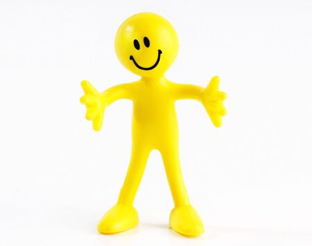 A smiling yellow figure with arms outstretched on a white backgroundの写真素材