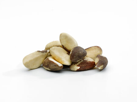 a pile of shelled Brazil nuts on a white backgroundの写真素材