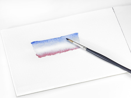 a single watercolour brush, paint and padの写真素材