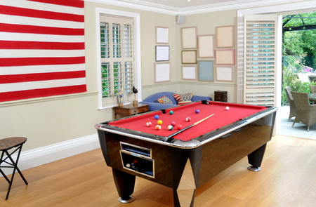 A pool table in an American themed room