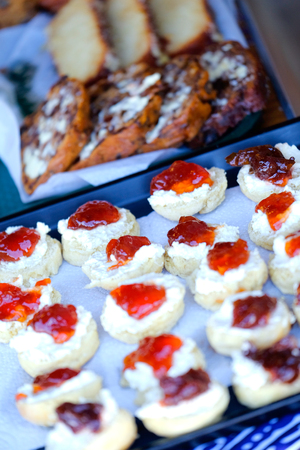 A selection of afternoon tea and cakes including scones and jamの写真素材