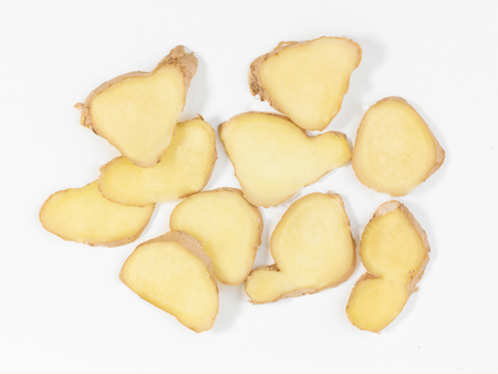 sliced ginger root on a white backgroundの写真素材