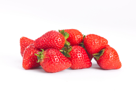 a pile of strawberrys on a white backgroundの写真素材