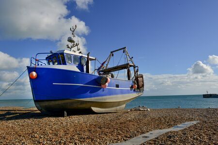 a single beached fishing boat on single beach の写真素材