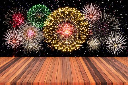 Abstract empty wooden floor with fireworks background. colorful fireworks over dark sky abstract for background. New Year celebration fireworks.の写真素材
