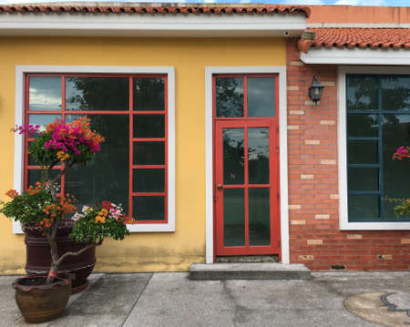 Abstract white door with yellow wall background. European style window with sand wall backgroundの写真素材