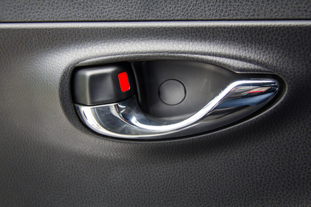 Handle car door. the close up image of inside old grey door car opener, unlock.の写真素材