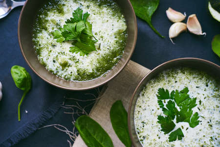 Soup with spinach, parsley and garlic on a tableの写真素材