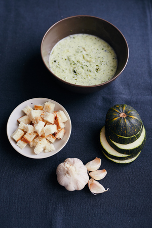 Cream soup of zucchini and garlic with croutonsの写真素材