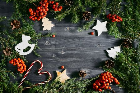 top view of Christmas toys. on the table mountain ash, spruce branches. mockup for designersの写真素材