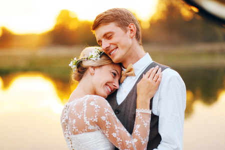 Portraits of a newly married couple. The wedding couple is standing on the background of the order. Lovers are happy.の写真素材