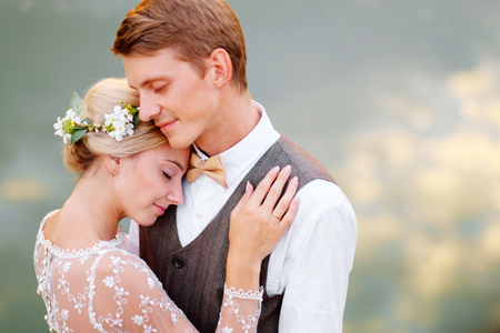 Portrait of the bride and groom close-up on the background of waterの写真素材