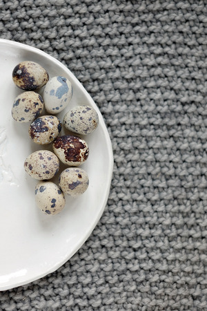 Quail eggs on a plate. Decorative plate with a patternの写真素材