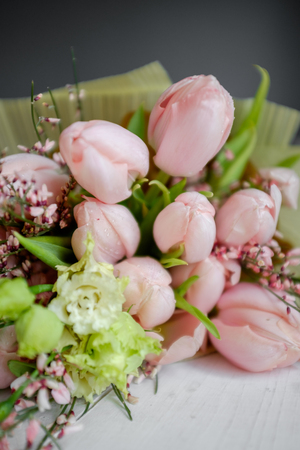 Bouquet of delicate pink tulips on the tableの写真素材