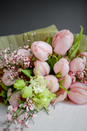 Bouquet of delicate pink tulips on the tableの写真素材