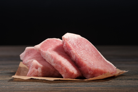 Fresh raw pork steaks on paper.の写真素材