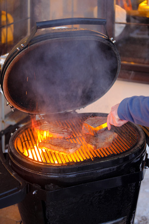 The process of making grilled steaks on hot grillの写真素材