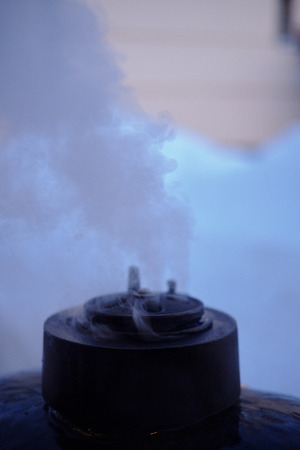 Smoke from a food smoker chimney close-upの写真素材