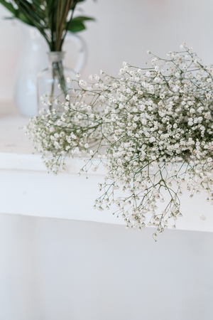 Bouquet of gypsophila lies on the white  tableの写真素材