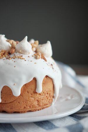 Easter cake with white icing on a plateの写真素材