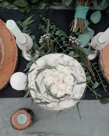 Beautiful cake in rustic style decorated with twigs of eucalyptus plantsの写真素材