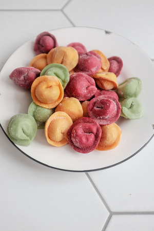 Multicolored dumplings stuffed with meatの写真素材