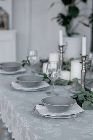 Wedding or festive table setting. Plates, wine glasses, candles and cutlery . Beautiful arrangement.の写真素材