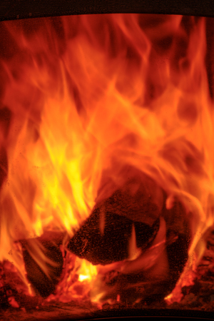 Burning and glowing pieces of wood in fireplaceの写真素材