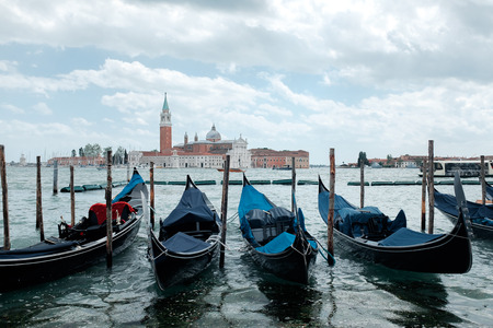 Tour to Venice. Gondolas and boats on the water channel of Veniceの写真素材