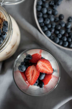 A healthy breakfast with blueberries and strawberries. Dessert in a glass