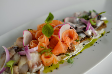 Fish mix with vegetables. Cold appetizer. White backgroundの写真素材