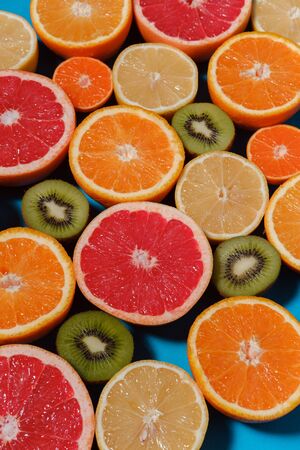 Close up of citrus fruits. Sliced fruits background. Selective focus. Concept: fresh fruit, summer...
