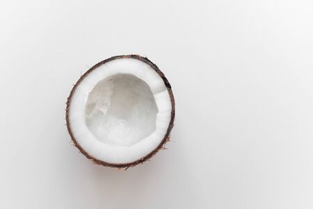half coconut on a white background isolated. view from above. loneliness conceptの写真素材