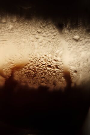 misted glass. fragment. condensate on a glass. dark background