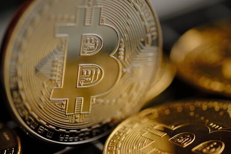 Bitcoins and a new concept of virtual money. Gold coins with letter B icon. close-up. illegal income...