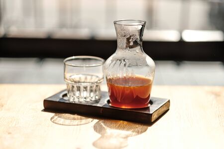 on the table is a jar of alternative coffee and a glass. Hario v60. concept filter Coffee