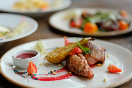 Delicious dish with pear, strawberries sauce. business lunch. restaurant serving.