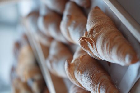Many fresh croissants on a wooden tray. home bakery concept. Cafe. gluten free. top view