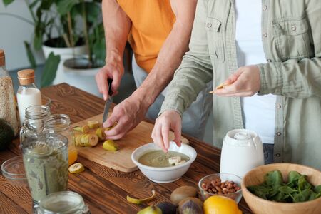 Young married couple is preparing a smoothie. Ingredients for smoothies. The concept of healthy...