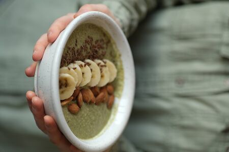 girl holding a green smoothie bowl. veggie concept. vegansの写真素材