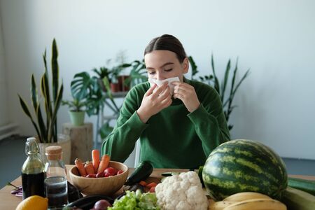 Caucasian woman has runny and common cold. Sick woman with seasonal infections, flu, allergyの写真素材