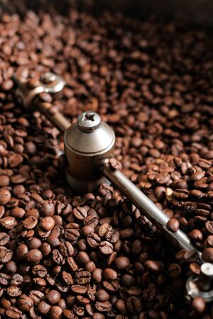 The freshly roasted coffee beans from a large coffee roaster in the cooling cylinder.の写真素材