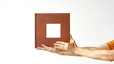 leather bound photo album in hand. Mock up photobook. design concept.の写真素材