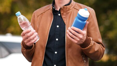 Hard choice. Concept of zero waste lifestyle of using refillable bollte instead of single use...
