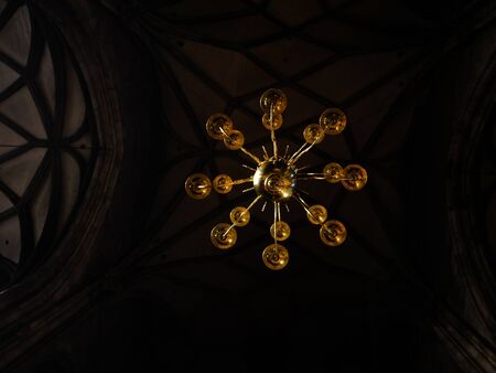 Antique chandelier hanging in an old European building, bottom view