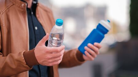 Hard choice. Concept of zero waste lifestyle of using refillable bollte instead of single use plasticの写真素材