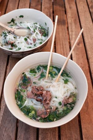 two plates of pho bo. Vietnamese soup pho bo. Panasian cuisine. Veal and Noodle Soupの写真素材