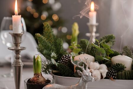 fragments of Christmas decor, cones, candles on the background of a decorated Christmas tree. New...