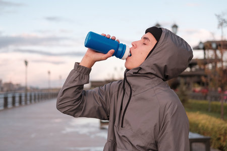 young man with reusable plastic bottle for water. zero waste concept. perprabotka. Ecology. eco...