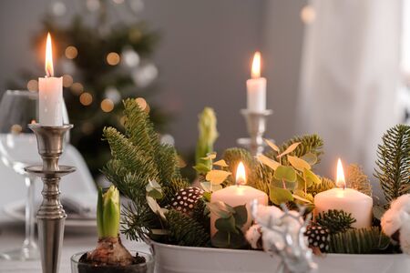 fragments of Christmas decor, cones, candles on the background of a decorated Christmas tree. New year conceptの写真素材
